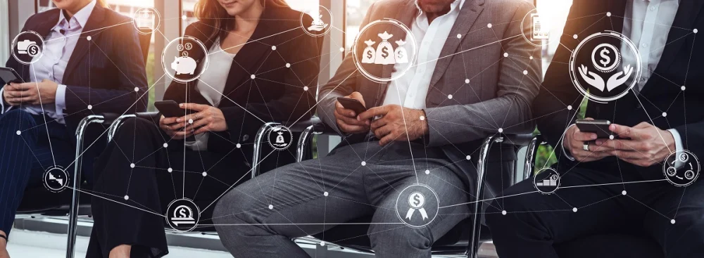 A group of business professionals sitting in a row using mobile devices, overlaid with network icons representing financial data, identity signals, and transaction monitoring used in KYC risk assessment.