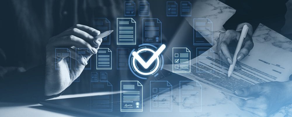Hands reviewing business documents with digital checkmark icons, illustrating KYB document verification, compliance review, and corporate due diligence